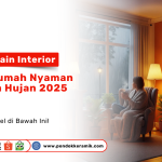 Tren Desain Interior untuk Rumah Nyaman di Musim Hujan 2025. Seorang wanita menikmati minuman hangat di sofa dekat jendela, dengan pemandangan hujan, suasana ruang tamu terasa hangat dan nyaman.